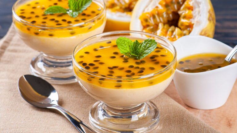 Mousse de Maracujá em taça, decorada com sementes e raspas de chocolate.
